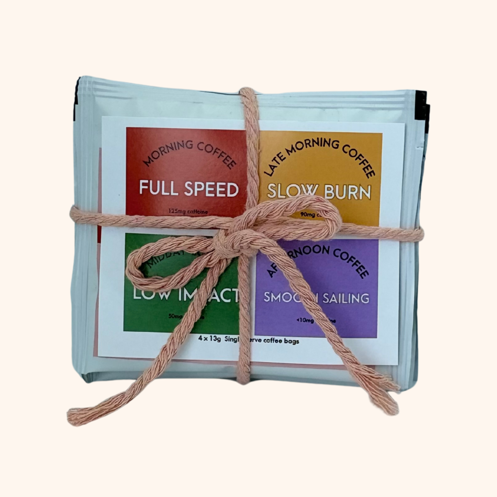Pack of coffee bags with colorful labels tied together with string on a white background
